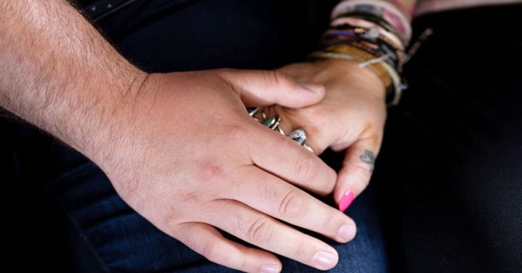 Close-up of partners holding hands as Dr. Mike shares how experimentation with different positions, devices, or expressions of sexuality can enrich the intimate relationships of those with disabilities.