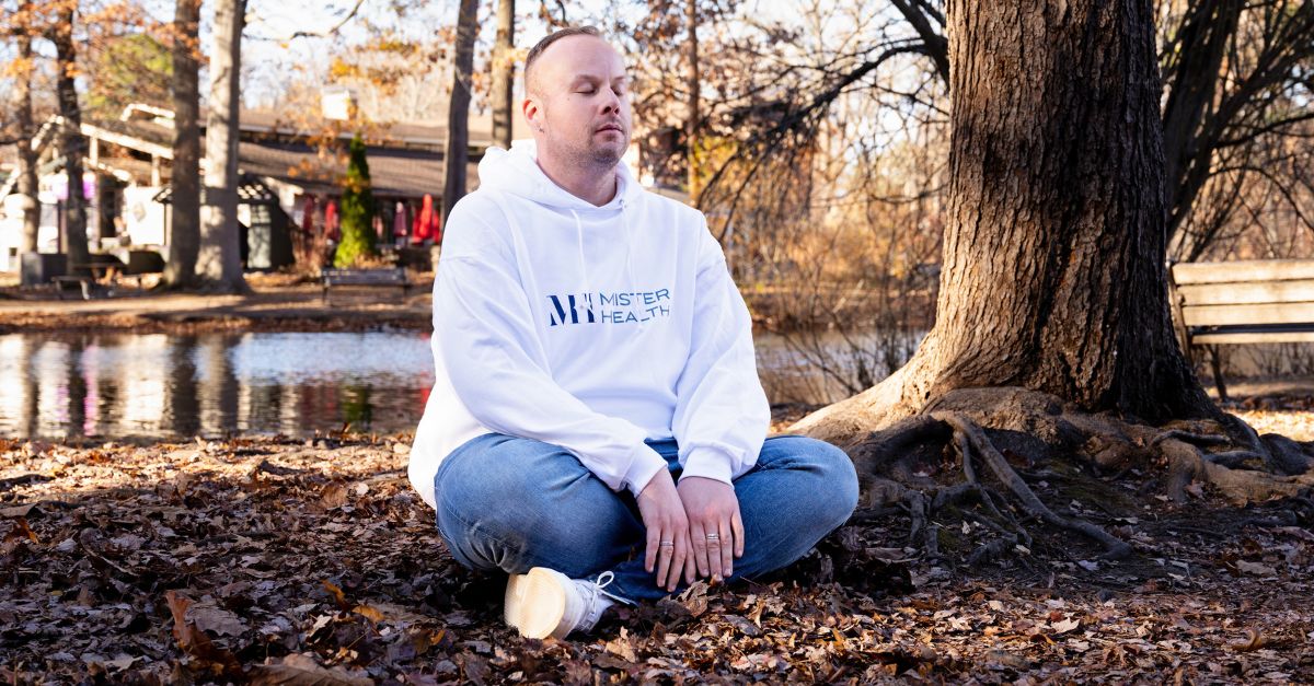 Dr. Mike sits in contemplative thought in a park.